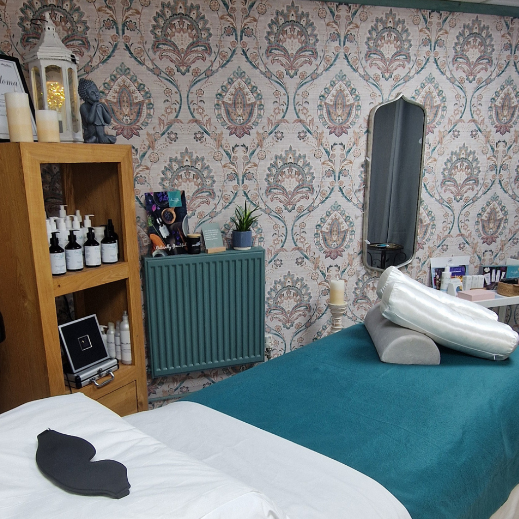 Private Reiki treatment room at The Nook Yoga Studio in Tewkesbury featuring a comfortable treatment couch, eye mask, soft furnishings, and a calming wellbeing environment.